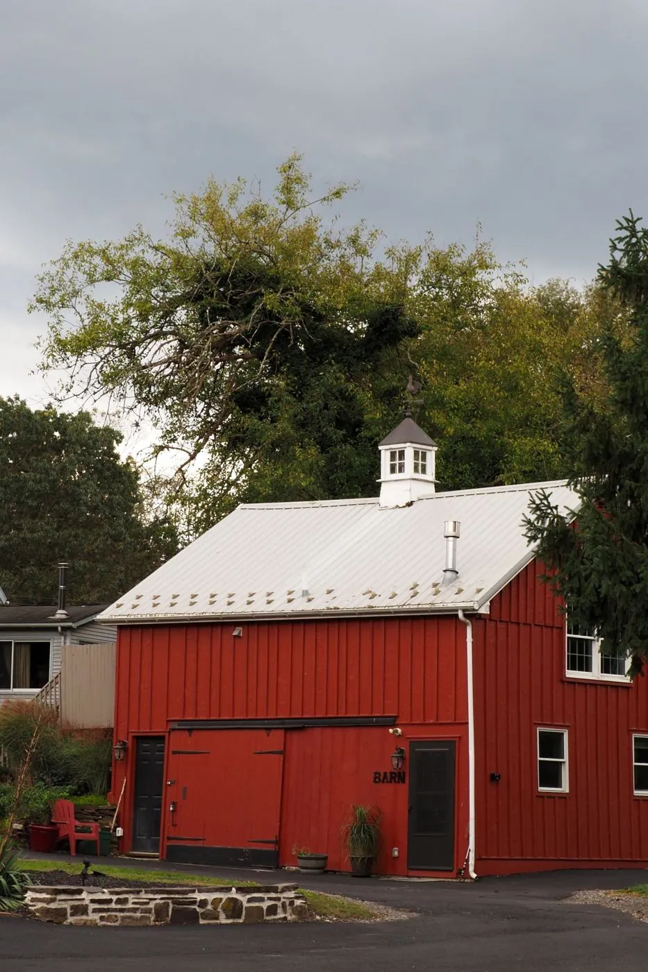Red barn among trees in Doylestown, PA, an area served for septic pumping and inspections